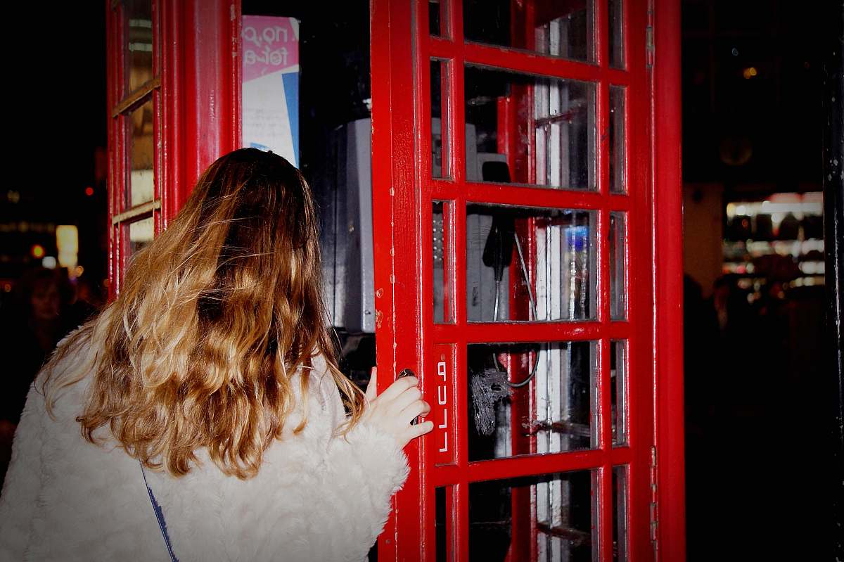 china town woman about to open the phone booth united kingdom